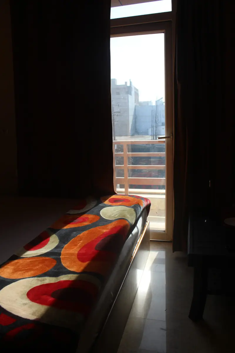 Bed, television and wardrobe in a guest room at Hotel RK Inn.