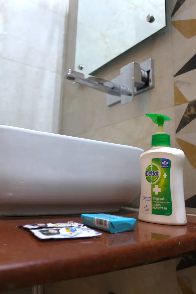 Bathroom sink with fresh toiletries at Hotel RK Inn.
